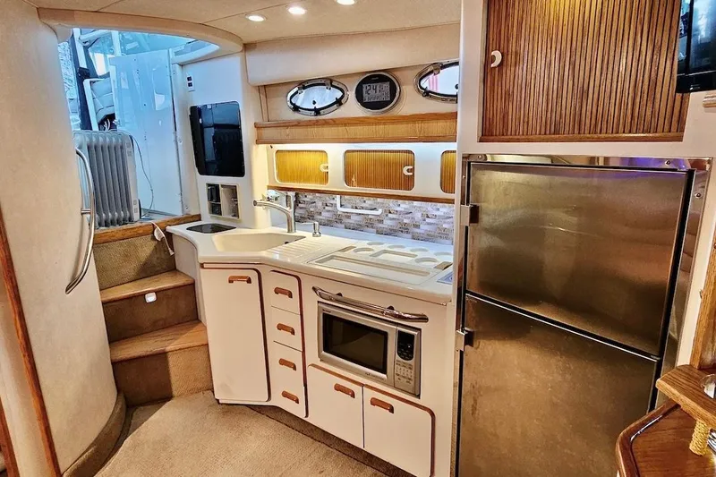 Slide: The Image of Luxurious 1994 Sea Ray 440 Sundancer yacht interior with modern kitchen amenities. - 18