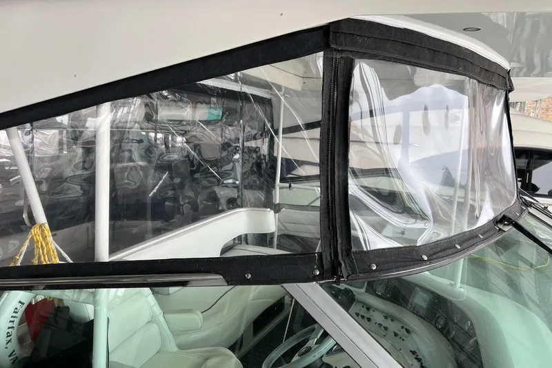 Slide: The Image of 1994 Sea Ray 440 Sundancer yacht docked, showcasing sleek deck design and railing. - 2