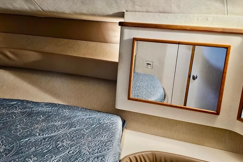 Slide: The Image of Cozy cabin interior of 1994 Sea Ray 440 Sundancer with plush bedding and ambient lighting. - 20