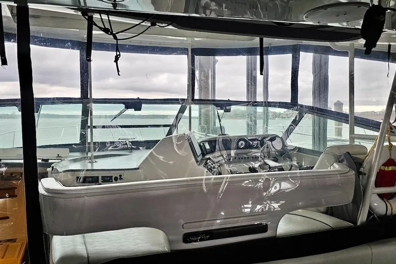 Slide: The Image of Cockpit of 1994 Sea Ray 440 Sundancer with steering wheel and navigation equipment. - 6