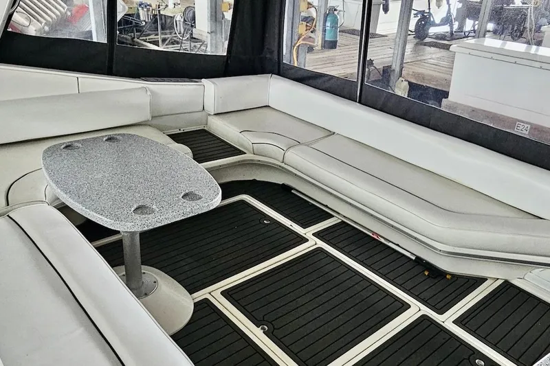 Slide: The Image of Interior of 1994 Sea Ray 440 Sundancer yacht with seating and table. - 8