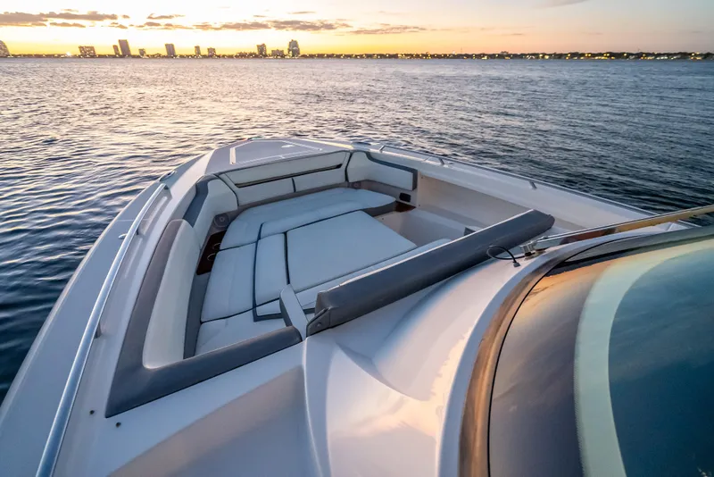 Slide: The Image of 2019 Tiara Yachts 38 LS on water at sunset, city skyline in background. - 15