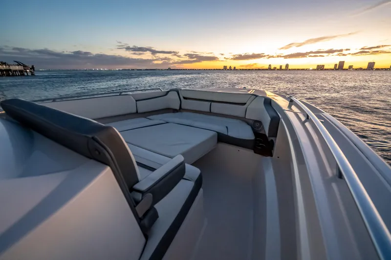 Slide: The Image of 2019 Tiara Yachts 38 LS at sunset, featuring luxurious seating and ocean view. - 16