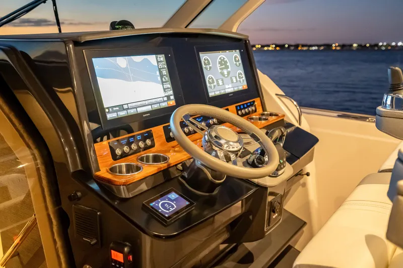 Slide: The Image of Helm of 2019 Tiara Yachts 38 LS with advanced navigation displays at sunset. - 18