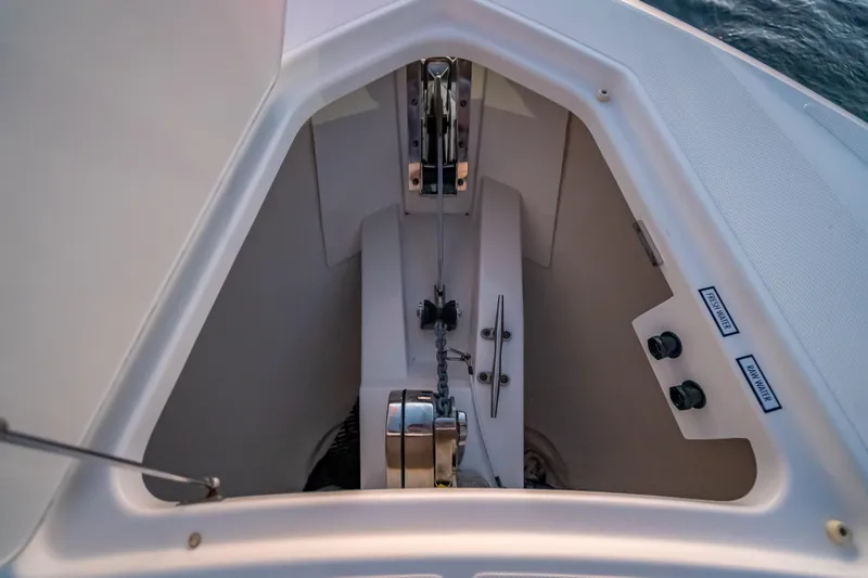 Slide: The Image of Anchor compartment of 2019 Tiara Yachts 38 LS, featuring chain and controls. - 19