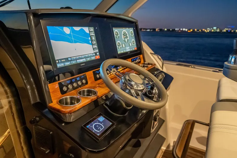 Slide: The Image of Cockpit of 2019 Tiara Yachts 38 LS with advanced navigation displays at dusk. - 23