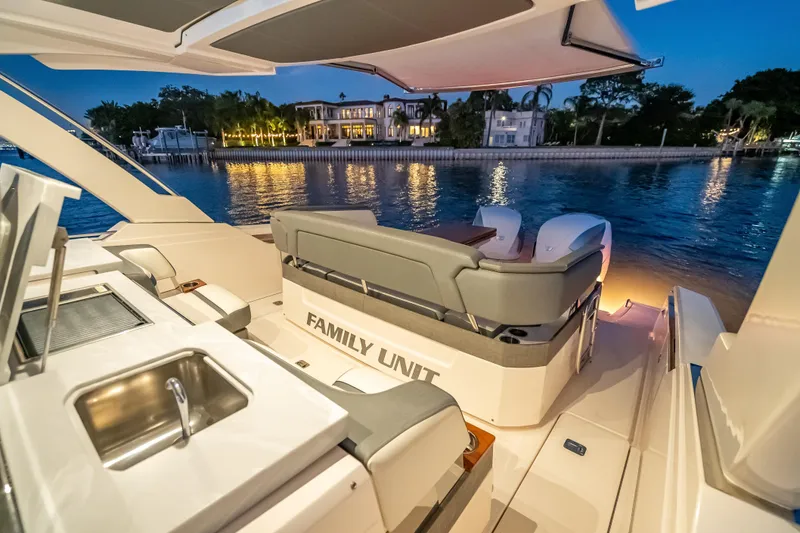 Slide: The Image of Luxurious 2019 Tiara Yachts 38 LS boat interior at sunset, docked by waterfront homes. - 25