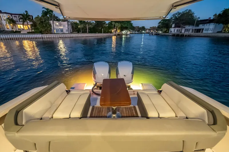 Slide: The Image of Luxurious 2019 Tiara Yachts 38 LS with elegant seating, docked at sunset. - 26