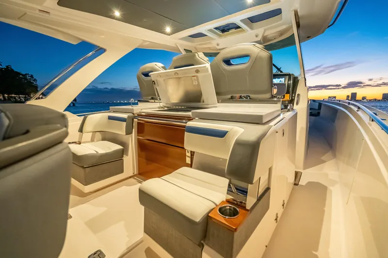 Slide: The Image of Luxurious 2019 Tiara Yachts 38 LS interior at sunset, featuring elegant seating and modern design. - 27