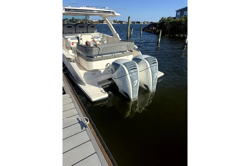 Slide: The Image of 2019 Tiara Yachts 38 LS docked at marina, calm waters, clear sky. - 3