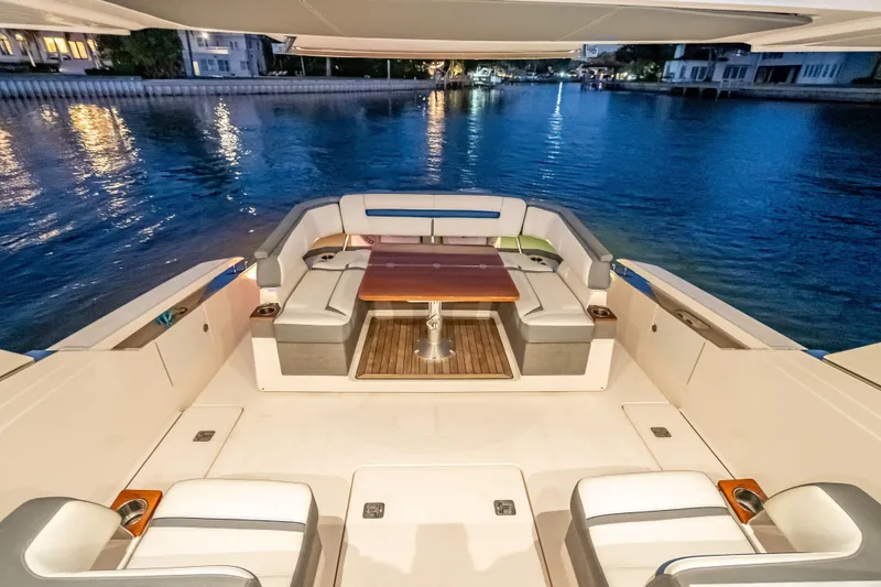 Slide: The Image of Luxurious 2019 Tiara Yachts 38 LS with elegant seating and scenic waterfront view. - 31