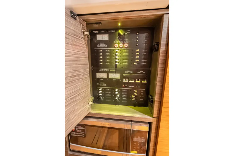Slide: The Image of Electrical panel inside 2019 Tiara Yachts 38 LS, showcasing AC and DC systems. - 36