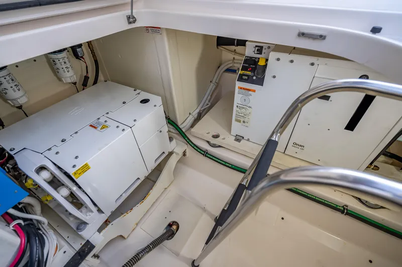 Slide: The Image of Engine compartment of 2019 Tiara Yachts 38 LS, featuring Onan generator and electrical components. - 38