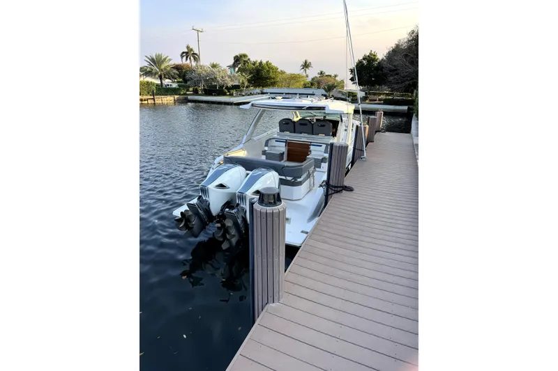 Slide: The Image of 2019 Tiara Yachts 38 LS docked by a serene waterfront. - 4