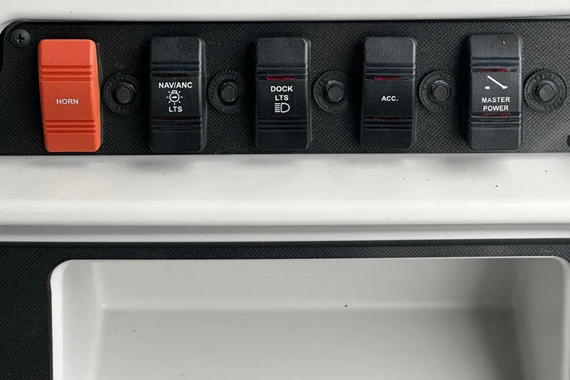 Slide: The Image of Control panel of 2026 Sweetwater EX 2286 SFLX with labeled switches for horn, lights, and power. - 11