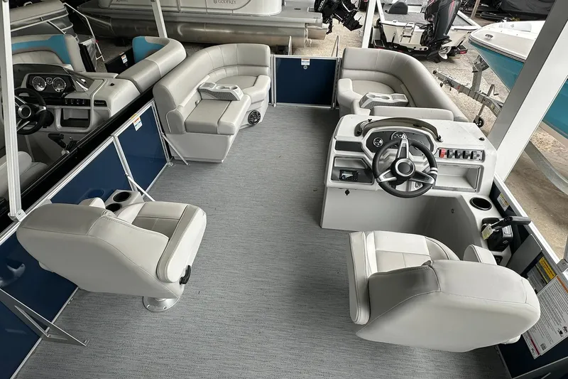 Slide: The Image of 2026 Sweetwater EX 2286 SFLX pontoon boat interior with plush seating and modern helm. - 13