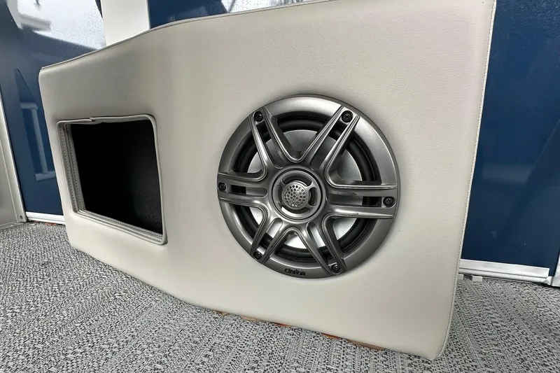 Slide: The Image of 2026 Sweetwater EX 2286 SFLX boat speaker and storage compartment on textured flooring. - 15