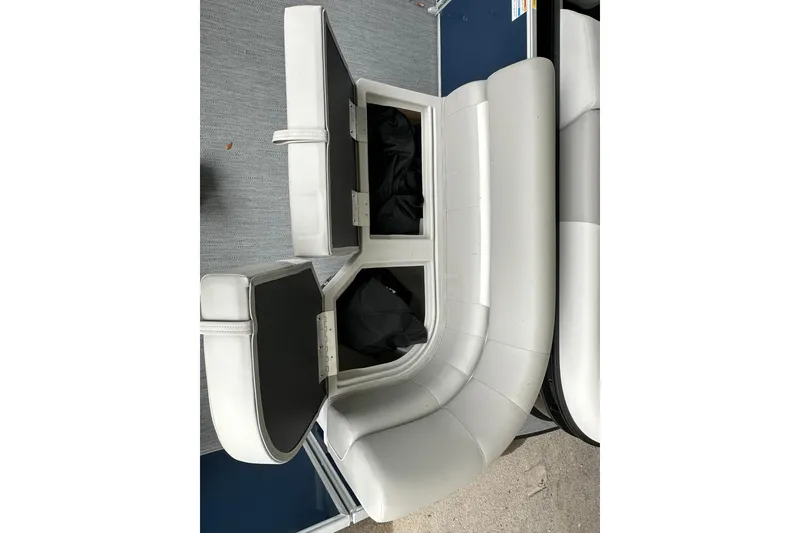 Slide: The Image of 2026 Sweetwater EX 2286 SFLX boat seating with open storage compartments. - 19