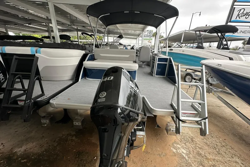Slide: The Image of 2026 Sweetwater EX 2286 SFLX pontoon boat with Suzuki outboard motor in a showroom. - 22