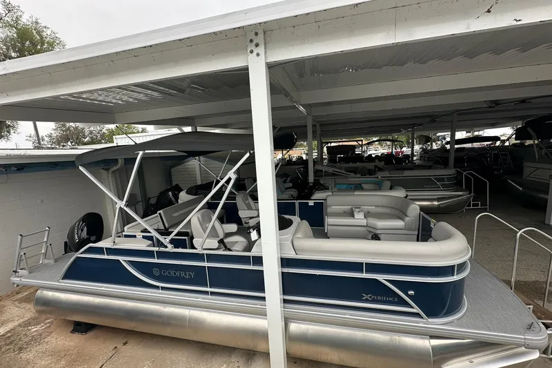 Slide: The Image of 2026 Sweetwater EX 2286 SFLX pontoon boat under covered storage. - 3