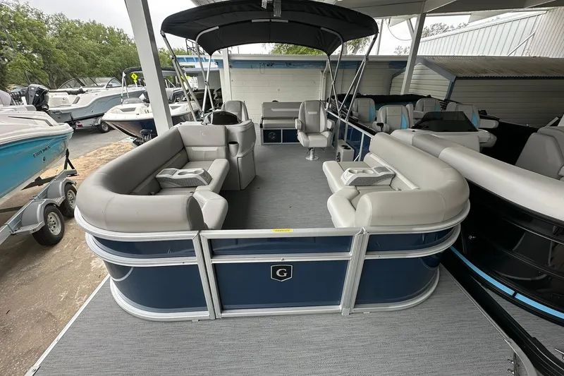 Slide: The Image of 2026 Sweetwater EX 2286 SFLX pontoon boat with spacious seating and canopy. - 4