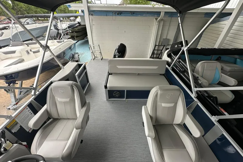 Slide: The Image of 2026 Sweetwater EX 2286 SFLX pontoon boat interior with seating and canopy. - 8