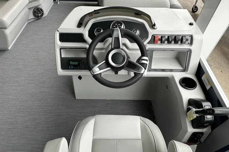 Slide: The Image of 2026 Sweetwater EX 2286 SFLX boat helm with steering wheel and control panel. - 9