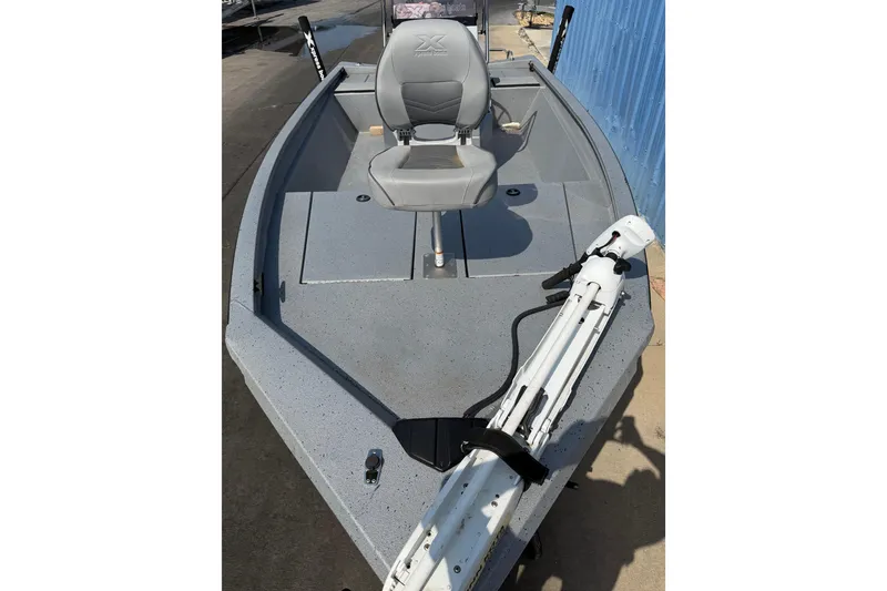 Slide: The Image of 2024 Xpress H190B Bay boat with gray seating and deck, featuring a mounted trolling motor. - 12