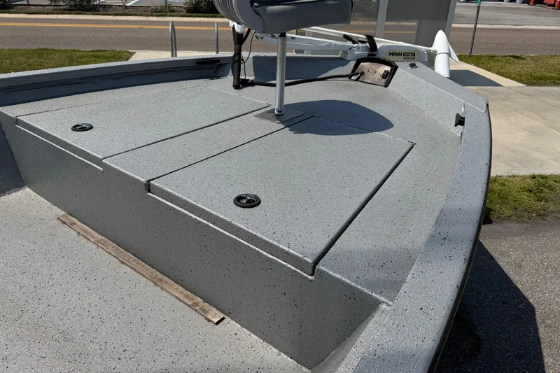 Slide: The Image of 2024 Xpress H190B Bay boat deck with storage compartments and seating. - 13