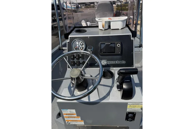 Slide: The Image of 2024 Xpress H190B Bay boat dashboard with steering wheel and controls. - 9