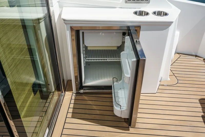 Slide: The Image of Open refrigerator on the deck of a 2019 Cruisers 50 Cantius yacht. - 43