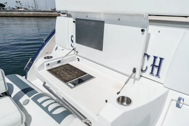 Slide: The Image of The image shows the stern of a 2019 Cruisers 50 Cantius with a built-in grill station. - 39