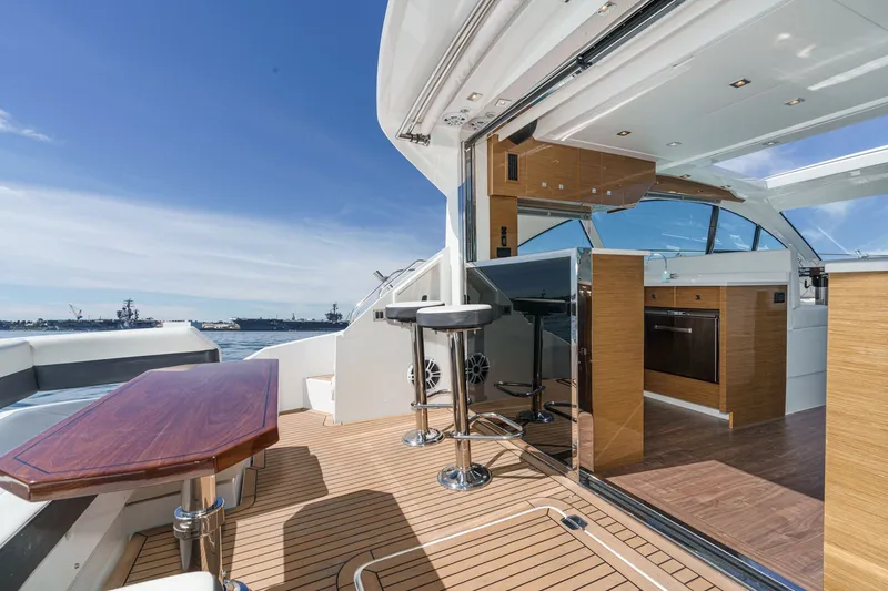 Slide: The Image of The image shows the deck of a 2019 Cruisers 50 Cantius yacht with modern interior. - 48