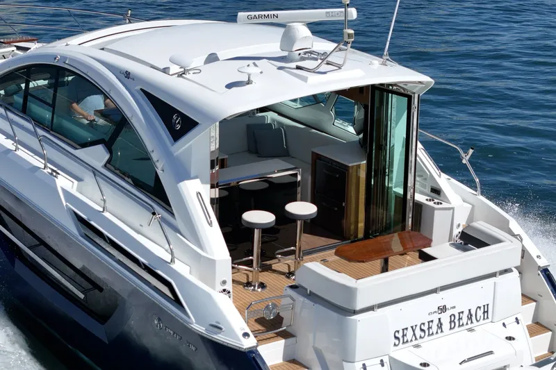 Slide: The Image of 2019 Cruisers 50 Cantius on the water with open cockpit and modern amenities. - 40