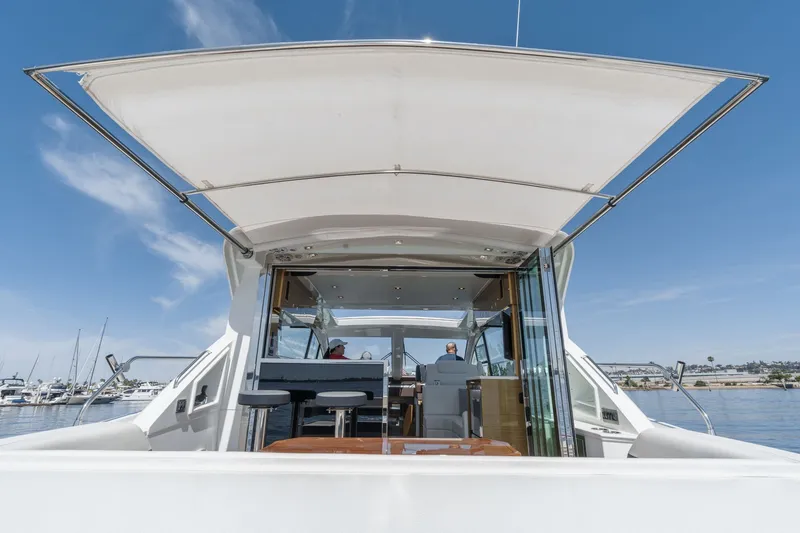 Slide: The Image of The image shows the stern of a 2019 Cruisers 50 Cantius yacht with an open cockpit. - 44