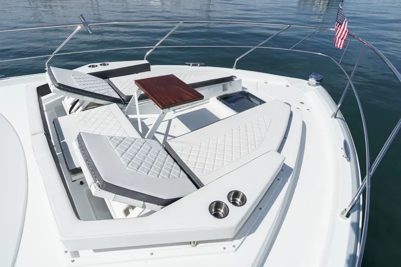 Slide: The Image of The 2019 Cruisers 50 Cantius features luxurious loungers and a table on the foredeck. - 34