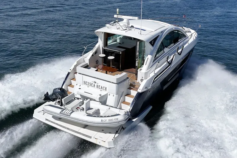Slide: The Image of A luxury motor yacht speeds across the water, featuring an open deck and modern amenities. - 36
