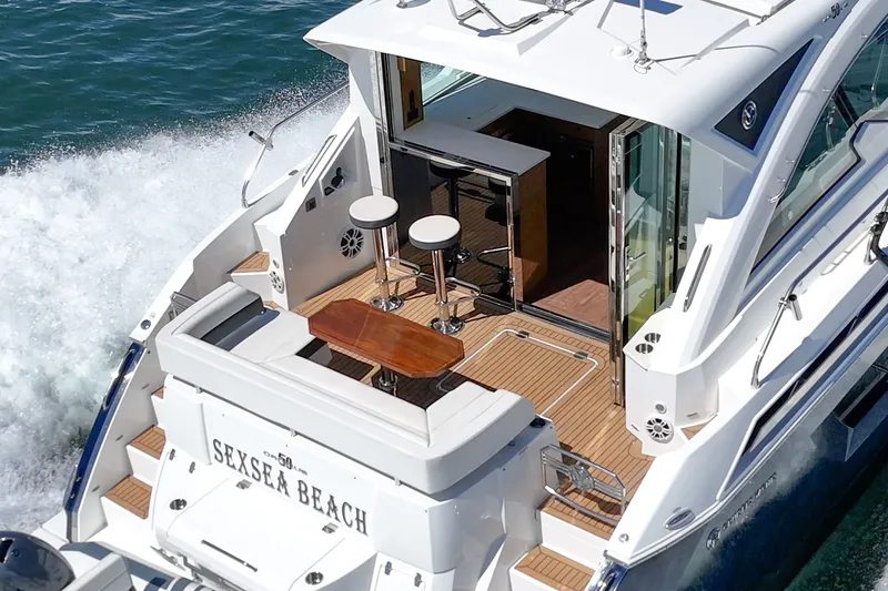 Slide: The Image of The image shows the stern of a 2019 Cruisers 50 Cantius yacht on the water. - 37