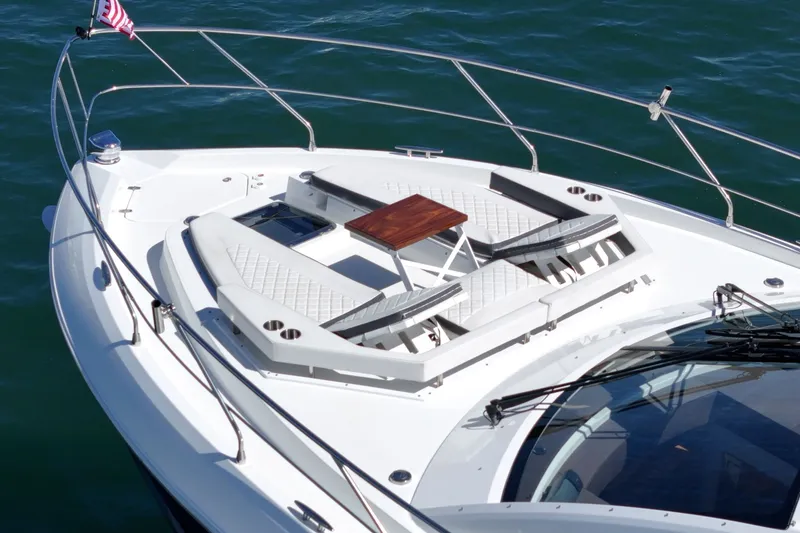 Slide: The Image of The 2019 Cruisers 50 Cantius features a bow deck with two cushioned loungers and a wooden table. - 33