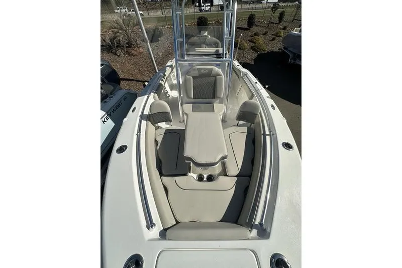 Slide: The Image of 2026 Key West 219 FS boat interior with cushioned seating and center console. - 1