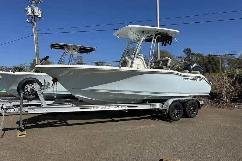 Slide: The Image of 2026 Key West 219 FS boat on trailer under clear blue sky. - 3
