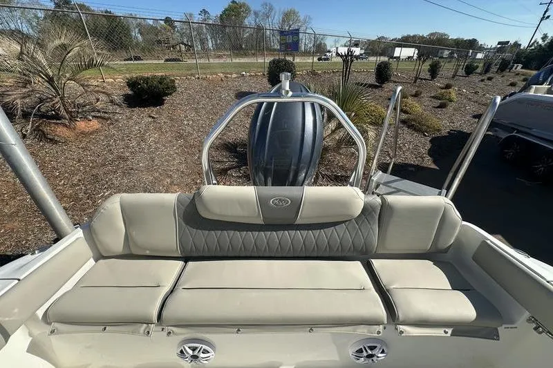 Slide: The Image of 2026 Key West 219 FS boat interior with cushioned seating and stainless steel railing. - 4
