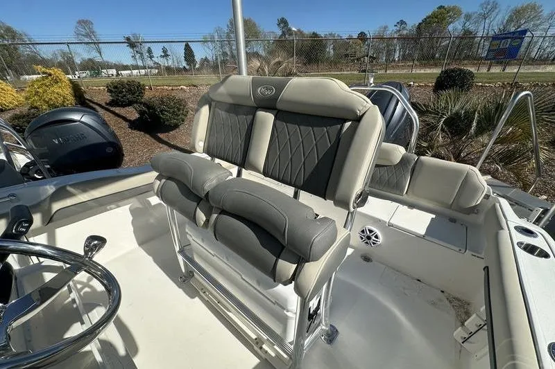 Slide: The Image of 2026 Key West 219 FS boat interior with cushioned seating and steering wheel. - 5