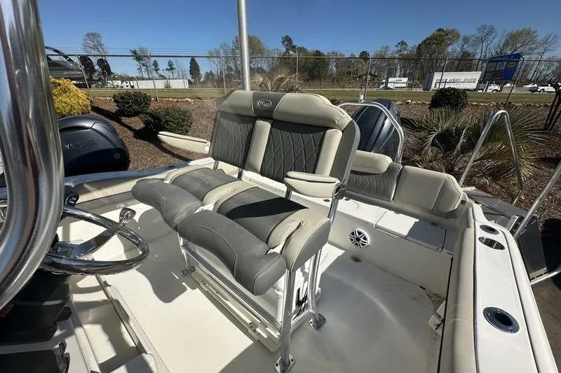 Slide: The Image of 2026 Key West 219 FS boat interior with cushioned seating and steering wheel. - 6