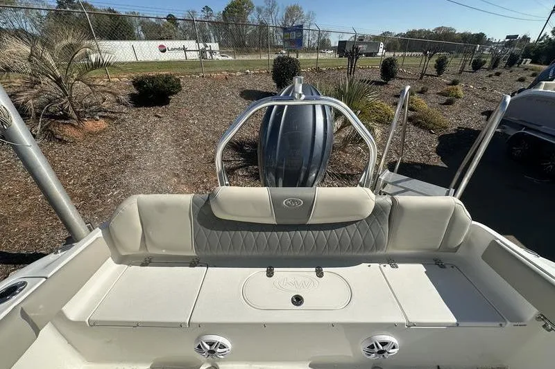 Slide: The Image of 2026 Key West 219 FS boat interior with seating and engine view. - 7