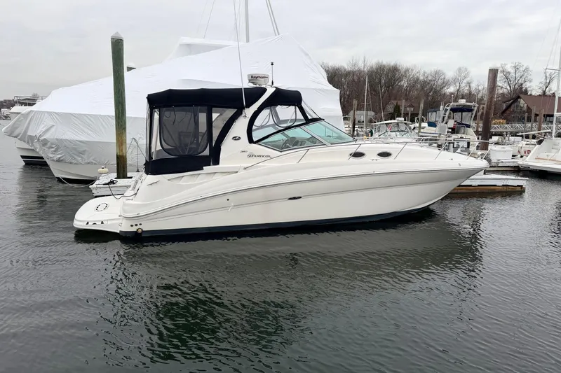 Slide: The Image of 2007 Sea Ray Sundancer 320 yacht docked in a marina, featuring sleek design and covered cockpit. - 1