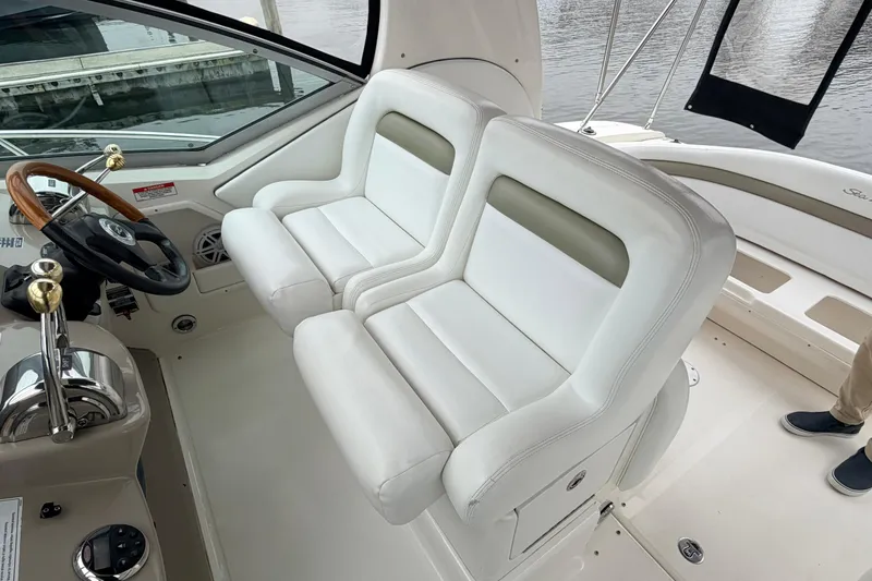 Slide: The Image of Interior of 2007 Sea Ray Sundancer 320 boat with white leather seating and steering wheel. - 10
