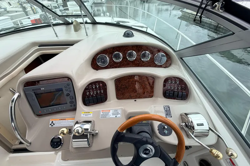 Slide: The Image of Cockpit of 2007 Sea Ray Sundancer 320 with steering wheel and navigation controls. - 13