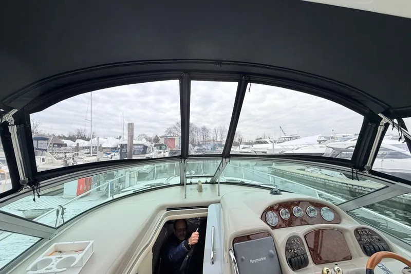 Slide: The Image of 2007 Sea Ray Sundancer 320 cockpit view with marina background. - 14