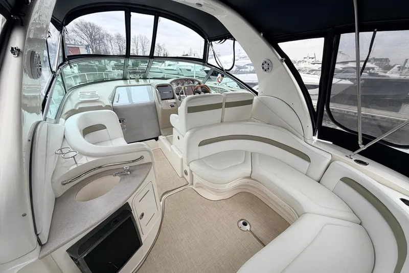 Slide: The Image of 2007 Sea Ray Sundancer 320 interior with plush seating and modern helm controls. - 15